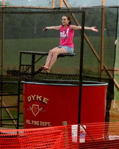 a woman in pink shirt jumping on trampoline