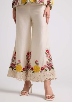 Step into elegance with this ivory floral chanderi bell bottom pants, intricately detailed with delicate threadwork and exquisite beadwork. These pants exude sophistication and charm, adding a touch of refinement to any ensemble. Elegant Floral Embroidered Festive Pants, Elegant Floral Embroidered Pants For Festive Occasions, Festive Wide Leg Palazzo Set With Floral Embroidery, Anarkali Bottoms With Resham Embroidery For Wedding, Off White Sharara With Floral Embroidery For Festive Occasions, Elegant Festive Pants With Floral Embroidery, Wedding Pants For Eid With Floral Embroidery, Elegant Flared Bottoms For Wedding, Elegant Bottoms With Resham Embroidery For Spring