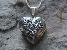 "Beautiful silver plated heart locket. It holds 2 photos and/or a treasured keepsake, please see the photos for size. The locket comes with a matching 20\" silver plated snake chain. If you would like a different length, please leave a note at checkout or just message me. Please do visit my shop, there is so much to see and something for everyone. Thanks so much...Lisa" Silver Heart Locket Necklace For Wedding, Silver Heart-shaped Jewelry With Rose Design, Silver Heart Charm Locket Necklace For Wedding, Sterling Silver Locket Necklace For Wedding On Valentine's Day, Nickel-free Heart Locket Necklace For Wedding, Nickel Free Heart Locket Necklace For Wedding, Silver Heart Pendant Locket Necklace For Weddings, Heart-shaped Rose Design Jewelry For Wedding, Heart-shaped Rose Design Wedding Jewelry