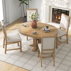 a dining room table with chairs and a vase filled with flowers on top of it