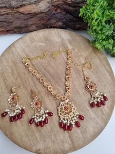 This stunning jewellery set from My Jewel Box is perfect for any special occasion. The Rajwari Gold Look Set comes with a gorgeous pair of earrings and a tikka, all featuring multiple natural stones in a beautiful multicoloured design. The set is perfect for anyone looking for Indian/Pakistani bridalwear or partywear jewellery. The excellent cut grade and natural stone creation make this set a high-quality and unique choice. Whether you're celebrating an engagement, wedding, anniversary, birthda Festive Navratri Sets With Intricate Design, Festive Sets With Intricate Design For Navratri, Intricate Design Sets For Wedding And Navratri, Eid Celebration Stone Work Tikka, Temple Jewelry Style Tikka For Eid Celebration, Temple Jewelry Tikka For Eid Celebration, Elegant Chandbali Jewelry Sets With Zari Work, Eid Celebration Temple Jewelry Tikka, Bollywood Bridal Sets With Intricate Design For Festive Occasions