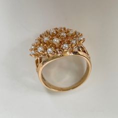 This is a fun cluster seed Pearl ring with nice finger coverage! A great statement ring crafted in 14K Yellow gold, circa 1950s. Each pearl is securely held with organic looking prongs. The shank has a nice split on the sides and tapers down to 2.68 mm at the bottom. This is the perfect ring for the lady born in June. 7.28 grams 14k yg People have coveted natural pearls as symbols of wealth and status for thousands of years. A Chinese historian recorded the oldest written mention of natural pear Vintage White Cluster Diamond Ring, Vintage Yellow Gold Cluster Jewelry, Vintage Yellow Gold Cluster Ring, Vintage Cluster Rings For Gifts, Vintage Cluster Rings As Gift, Vintage Oval Flower Ring, Vintage Cluster Ring Suitable For Gifts, Vintage Flower Ring For Anniversary, Collectible Vintage Flower Ring