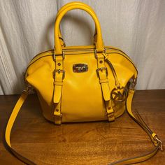 Perfect Condition. Practically Brand New. Carried Once And Kept In Silk Purse Bag. Michael Kors Canary Yellow (Color Sun) Leather Satchel/Purse With Detachable Shoulder Strap. Double Rolled Leather Handles. 9” Tall (Without Handles), 14.5” With Handles Standing Upright, 13.5 Inches Wide, 7” Deep. Silver Hardware. Gorgeous Shape And Huge Capacity For All Your Needs. One Large Internal Space With A Side Zippered Compartment And Four Small Side Pockets. Stunning! Luxury Yellow Crossbody Satchel, Designer Yellow Satchel With Handles, Yellow Rectangular Bag With Branded Hardware, Designer Yellow Satchel With Double Handle, Designer Yellow Satchel With Detachable Strap, Yellow Rectangular Bags With Branded Hardware, Yellow Travel Bag With Branded Hardware, Designer Yellow Satchel For Travel, Classic Yellow Satchel With Gold-tone Hardware