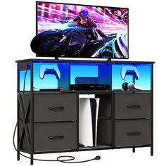 an entertainment center with a tv and video game controllers on it's sides, in front of a white background