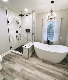 a white bath tub sitting next to a walk in shower