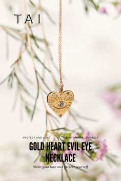 A gold necklace featuring a heart-shaped pendant with an evil eye design, embellished with colorful accents, hanging delicately against a soft, floral backdrop. Gold Heart Evil Eye Jewelry, Heart-shaped Gold Evil Eye Jewelry, Gold Heart-shaped Evil Eye Jewelry, Gold Spiritual Heart Necklace, Spiritual Gold Heart Necklace, Gold Heart-shaped Spiritual Necklace, Symbolic Gold Heart-shaped Necklaces, Heart Evil Eye, Set Yourself Free