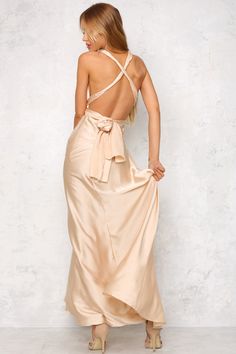 The Mind And Memory Maxi Dress has a smooth, silky fabric that glides over the body. A plunging v-neckline is secured with long halter-neck ties that fall gracefully over an exposed back. A hidden back zipper with a hook and eye closure holds the dress in at the waist. We love this dress with delicate gold jewellery! Maxi dress. Not lined. Cold hand wash only. Model is standard XS and is wearing XS. True to size. Slightly stretchy fabric. Polyester. Satin Dresses With Lace-up Low Back, Satin Maxi Dress With Tie Back, Silk Halter Dress With Tie Back For Formal Occasions, Silk Halter Dress With Tie Back For Formal Events, Formal Silk Halter Dress With Tie Back, Chic Halter Dress With Bow Tie Back, Silk Halter Neck Maxi Dress With Tie Back, Silk Halter Backless Dress With Back Opening, Chic Backless Satin Maxi Dress