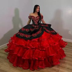 Command attention on your special day with this breathtaking Red Off-the-Shoulder Quinceanera Dress. This gown features a regal ball gown silhouette that cascades into a dramatic chapel train. The romantic off-the-shoulder neckline frames your shoulders beautifully, exuding elegance and charm. It is crafted from soft tulle fabric and is adorned with intricate appliques and playful ruffles, adding depth and texture to the voluminous skirt. The classic lace-up back ensures a secure and adjustable Quinceanera Dresses Mexican, Quince Dresses Charro, Quinceanera Dresses Red, Vestido Charro, Black Quinceanera Dresses, Mexican Quinceanera Dresses, Quinceanera Themes Dresses, Charro Quinceanera Dresses, Dresses With Appliques