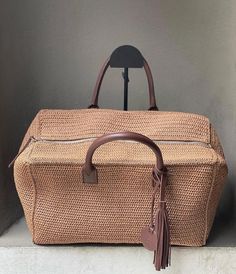 Luxury Handwoven Crochet Travel Bag, Beige Rectangular Straw Bag With Intrecciato Weave, Luxury Natural Crochet Bag With Intrecciato Weave, Luxury Natural Woven Crochet Bag, Beige Crochet Bag With Woven Leather Top Handle, Beige Crochet Top Handle Bag With Woven Leather, Luxury Handwoven Straw Bag For Travel, Luxury Brown Crochet Bag With Braided Handles, Brown Luxury Crochet Bag With Braided Handles