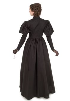 This is our top selling dress! Throughout the Victorian period, mourning would take place for two and a half years! During the first year, black was the only color worn by a widow. This mourning gown in all black has the silhouette of a classic Victorian style. The dress has a fitted waist with a V-shape in front. This dress has leg-o-mutton sleeves and a full skirt. Dress has high collar and front button closure. All in black, this dress is suitable for any woman in mourning. Hand wash or machi Witch Dresses, Black Victorian Dress, Colonial Clothing, Haunted Library, Fabric Reference, Witch Dress, Couture Bridal Gowns, Historical Dress, Dress Tutorials