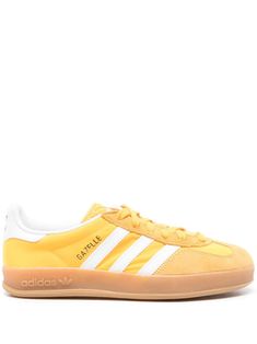 banana yellow/white calf suede front lace-up fastening panelled design contrasting branded heel counter padded ankle logo stamp at side signature 3-Stripes logo logo-embossed tongue round toe removable insole partial lining logo at the sole contrasting rubber sole Adidas Gazelle Indoor, Banana Yellow, Adidas Gazelle Sneaker, Summer Beach Wear, Adidas Gazelle, Derby Shoes, Suede Sneakers, Logo Stamp, Athletic Sneakers