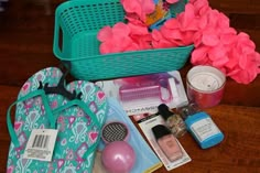 the contents of a purse are laid out on the floor next to flowers and other items