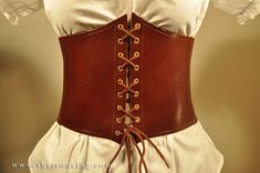 "This fully adjustable and detachable corset belt is made of pure leather and elastic Fabric for perfect fitting. It will give you the tipycal waspie shape. Two leather parts, the laced part (usually on the front) and the buckle and strip part for quick wear (usually on the back). It is perfect for different characters: Elves, celtic, peasant, renaissance and more. Available in basic colors (black, brown, natural) but you can ask for more colors with a custom order. The elastic band is only blac Steampunk Leather Corset Belt For Cosplay, Steampunk Leather Corset For Cosplay, Gothic Leather Corset Belt For Larp, Medieval Style Fitted Leather Corset, Medieval Leather Fitted Corset, Fitted Leather Medieval Corset, Brown Leather Steampunk Corset Belt, Brown Gothic Corset Belt For Cosplay, Steampunk Corset Belt For Cosplay