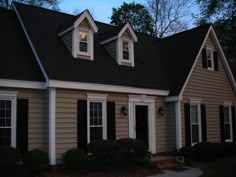 a house with black shutters and white trim