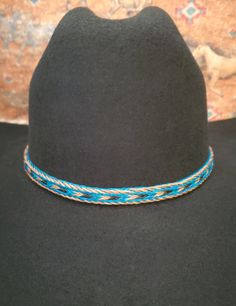 Braided Horse Hair Adjustable Hat Band in Brown/Black, Turquoise/Brown/Black, or Black/Brown/White, with 2 sliding knots make this hatband a great fit for most hats. This stunning hat band is made from genuine braided horse hair and will compliment your favorite cowboy hat.   - 3 braided strands are sewn together to create this gorgeous hatband. - Hat band measurements: approximately adjusts to 27.5" around and is 3/8 inch wide - Hat bands are shown on a size 7 hat.  Hats are not included. - See my horse hair KEEPSAKES to have a hat band made from your horse's hair:  https://www.etsy.com/shop/BlueEyesDesignsHB?ref=seller-platform-mcnav§ion_id=43697745 - See my HORSE HAIR hat bands:  https://www.etsy.com/shop/BlueEyesDesignsHB?ref=shop-header-name&listing_id=1296906619&from_page=listing&sec Casual Blue Hat Bands For Festivals, Adjustable Blue Hat Bands For Vacation, Adjustable Turquoise Hat For The Beach, Bohemian Blue Hat Bands For Vacation, Bohemian Blue Hat Band For Vacation, Adjustable Turquoise Hat For Vacation, Blue Flat Brim Hat Bands For Vacation, Casual Adjustable Turquoise Hats, Turquoise Casual Adjustable Hat