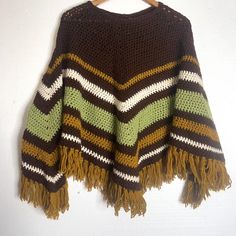 Vintage Handmade Crochet Brown Green Shawl Fringe Retro one size excellent pre owned condition boho, hippie, autumnal >> one size >> 25 x 56" Hippie Poncho For Fall, Hippie Fall Poncho One Size, Hippie Style Fall Poncho One Size, Hippie One-size Poncho For Fall, Bohemian Hand Knitted Poncho For Festivals, One Size Brown Fringe Poncho, Brown One Size Poncho With Fringe, Brown Fringe One Size Poncho, Hand Knitted Bohemian Poncho For Beach