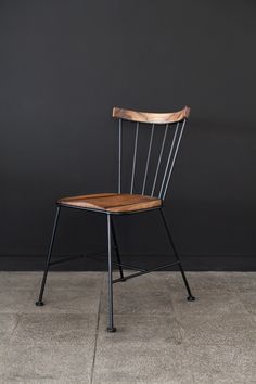 a wooden chair sitting on top of a cement floor