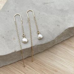 Minimalist Pearl Ear threader earrings, these dainty chain earrings with the perfect touch of femininity and it's great to combine with other earrings or wear alone for a minimalist look.Fun and delicate, these 14k gold-filled threader earrings come with wire bar ends on one side to make it easy to thread the chain through any pierced hole in your ear and on the other side, a small freshwater pearl. Mix and match with other HLcollection earrings for an edgy style statement or wear it on its own Dainty Adjustable Threader Earrings, Dainty Adjustable Threader Earrings With Pearl Drop, Delicate 14k Gold Filled Threader Earrings, Delicate 14k Gold-filled Threader Earrings, 14k Gold Filled Long Drop Linear Earrings, Hypoallergenic Yellow Gold Threader Drop Earrings, Gold 14k Threader Earrings For Everyday, Everyday 14k Gold Threader Earrings, Dainty Gold Plated Ear Climbers