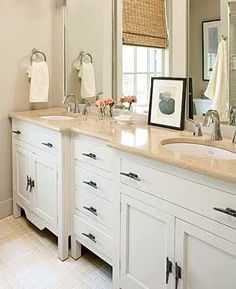 a bathroom with double sinks and two mirrors