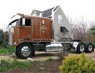 a large semi truck parked in front of a house