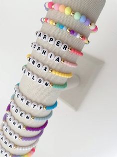 one colorful beaded name bracelet bracelets are made on a durable stretch elastic cord please refer to our sizing guide before purchasing Small Beaded Bracelets Rainbow, Name Beaded Bracelet, Friendship Bracelets Names, Adjustable Stretch Bracelet With Tiny Beads For Friendship, Adjustable Tiny Beads Stretch Bracelet For Friendship, Trendy Stretch Bracelet With Tiny Heishi Beads, Trendy Colorful Stretch Bracelet With Round Beads, Trendy Beaded Bracelets For Birthdays, Trendy Custom Name Jewelry With Round Beads