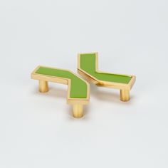 pair of green and gold cufflinks on white background