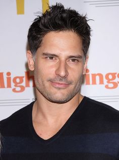 a close up of a person wearing a black and blue striped shirt with his hair pulled back