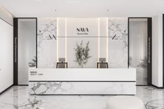 a white marble reception area with black and white accents