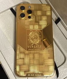 a gold versa phone case sitting on top of a table