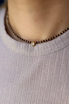 Delicate handmade short chocker necklace made with black and golden 1mm italian crystals. Finished with small white cubic zirconia pendant with 18K gold filled stainless steel 316 L stone fitting.  Made with strong and high quality cord.  All metal details are made from stainless steel 316 L.  Stainless steel doesn`t rust ,tarnish or change color.  D E T A I L S  Personalized lenght - from  36 cm to 42 cm  Lenght extension - 5 cm  Waterproof and hypoallergenic  Light and comfortable to wear  PAC Nalla Pusalu, Jewellery Concept, Wedding Jewelry Sets Bridal Jewellery, Neck Pieces Jewelry, Black Beads Mangalsutra Design, Mangalsutra Design, Black Beads Mangalsutra, Gold Mangalsutra Designs, Pearl Necklace Designs