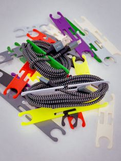 several pairs of scissors are laying on top of each other, with different colored handles