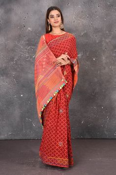 Leave a lasting impression with the most graceful Madhubani Saree in Red colour. Ace your ethnic style with this traditional attire that would grab all the eyeballs on a wedding occasion. This saree comes in silk fabric having numerable design patterns that have been woven in various colours. The diversity of colours makes the saree stand out. The borders of the saree have an exquisite design that is eye-catchy and has cute little different coloured tassels attached to it. Complete the look with Red Cotton Saree With Motifs, Red Semi-stitched Saree With Block Print, Red Saree With Woven Motifs, Festive Semi-stitched Cotton Saree, Red Semi-stitched Saree With Printed Motifs, Lambani Embroidery, Madhubani Saree, Cotton Sarees Online, Fashion Journals