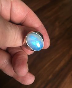 (MARKED DOWN FROM $50.00) This is a very unique ring I purchased in a vintage jewelry auction. Set in the antique silver plated setting is one beautiful chunk of oval RAINBOW MOONSTONE gemstone. The stone is not to large as you can see in the photo's. The ring is stamped 925 (very difficult to see, but it's there). The ring shows very little wear... mint condition! Ring Size: 10.5 Blue Rings With Large Stone For Healing, Unique Blue Cabochon Moonstone Ring, Unique Blue Moonstone Cabochon Ring, Unique Blue Moonstone Ring, Blue Moonstone Promise Ring, Blue Moonstone Healing Ring, Blue Moonstone Open Ring Gift, Blue Moonstone Round Rings, Blue Oval Moonstone Ring