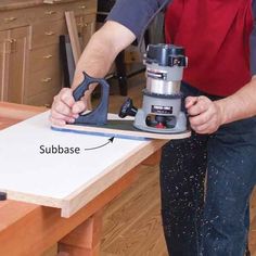 a person using a sander on a table