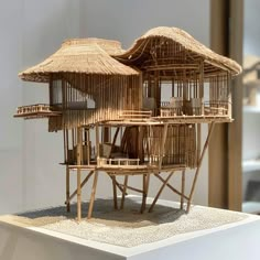 a model of a house made out of bamboo sticks