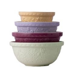 four different colored bowls stacked on top of each other