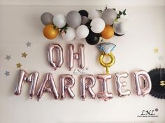 balloons that say oh married are hanging on the wall