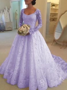 a woman in a purple wedding dress standing next to a mirror and looking at the camera