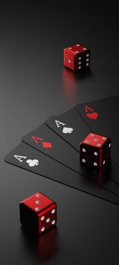 four red dices are sitting on top of each other in front of black cards