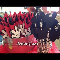 mickey mouse cupcake toppers in red and black paper cups with minnie mouse heads on them