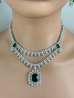 Emerald CZ diamond necklace, American Diamond wedding necklace, Cz jewelry, Indian, Pakistani, Punjabi wedding jewelry, Bridal necklace Regular Size And Adjustable with rhodium finish Ships from California, USA Delivery in 2-5 business days in the USA. Other colors can be found here https://www.etsy.com/listing/1423097794/sapphire-cz-diamond-bridal-necklace?ref=listings_manager_grid https://www.etsy.com/listing/1423095388/emerald-cz-diamond-bridal-necklace?ref=listings_manager_grid Color, shades, and texture displayed may slightly vary from the actual product due to digital image limitations. We request you consider these minor variations. Please expect the possibility of some slight imperfections when buying handmade jewelry. Please let me know if you have any questions. Arrives in a gift Wedding Diamond Necklace With Jewels In Cubic Zirconia, Silver Emerald Jeweled Necklace For Anniversary, Wedding Diamond Necklace With Cubic Zirconia, Wedding Cubic Zirconia Diamond Necklace, Diamond White Bridal Necklace With Cubic Zirconia, Diamond White Cubic Zirconia Bridal Necklace With Jewels, Anniversary Emerald Necklace With Cubic Zirconia Jewels, Elegant Emerald Cut Diamond Necklace For Wedding, Elegant Emerald Cut Solitaire Necklace For Wedding