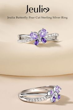 Like a tiny butterfly gracefully perched upon your finger, its wings shimmering with the brilliance of pear-shaped gems. Butterfly Cubic Zirconia Wedding Rings, Butterfly-shaped Cubic Zirconia Wedding Rings, Butterfly-shaped Cubic Zirconia Rings As Gifts, Elegant Butterfly Shape Gemstone Rings, Fine Jewelry Butterfly Rings, Butterfly Shape Fine Jewelry Rings As Gift, Fine Jewelry Butterfly Ring As Gift, Butterfly Shaped Fine Jewelry Ring For Gift, Gemstone Butterfly Ring For Anniversary