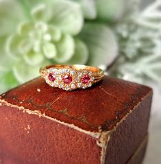 Vintage 18ct Gold, Ruby & Diamond Ring.  Hallmarked London 1983, Makers Mark J&P Size O (EU 56, US 7.5). Free Resizing Available - please message or email info@sobellejewellery.com Weight: 3.9g Rubies: 3 x 2mm Diamonds: 22 x 1mm Condition:  Good, clean vintage condition. All items will have a full professional clean and polish upon dispatch.  My items are all vintage so please study the photographs where I try to show as much detail as possible. Any damage or obvious imperfections will be clearl Exquisite Yellow Gold Multi-stone Diamond Ring, Victorian 14k Gold Diamond Ring With Gemstone, Exquisite Multi-stone Cluster Ring Gift, Heirloom Cubic Zirconia Multi-stone Diamond Ring, Exquisite Diamond Multi-stone Cluster Ring, Exquisite Multi-stone Diamond Cluster Ring, Fine Jewelry Anniversary Birthstone Ring With Rose Cut Diamonds, Exquisite Multi-stone Diamond Ring, Exquisite Diamond Cluster Ring With Multi-stone