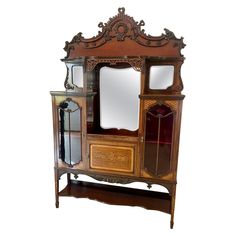 an old fashioned wooden cabinet with mirrors on it