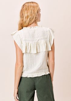 The prettiest bohemian-chic top in multi-textured cotton. Featuring delicate lattice trim inserts, a high neckline, and flirty ruffle details throughout. Flattering and unique, this boho top looks great alone or layered under your favorite cardigan. FINAL SALE Relaxed fit Ruffled cap sleeve Cropped length High ruffled neckline Button front Ruffle details Lattice trim inserts Model is 5'9, wearing a size S.Style: I-12531W-QSD Bohemian Top With Ruffled Collar, Spring Bohemian Tops With Ruffled Collar, Bohemian Sleeveless Top With Ruffle Hem, Bohemian Ruffled Collar Top For Summer, Sleeveless Bohemian Top With Ruffle Hem, Spring Top With Lace Trim And Ruffled Collar, Summer Bohemian Tops With Ruffled Collar, Bohemian Cotton Top With Ruffle Sleeves, Feminine Cotton Tops With Crochet Trim