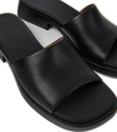 Modern Slip-on Slides With Textured Sole, Modern Slip-on Slides With Leather Sole, Modern Black Slides With Leather Sole, Sleek Leather Slip-on Slides, Modern Slip-on Slides, Modern Black Slide Mules, Modern Leather Slide Mules, Casual Leather Sandals For Work, Modern Synthetic Slip-on Slides