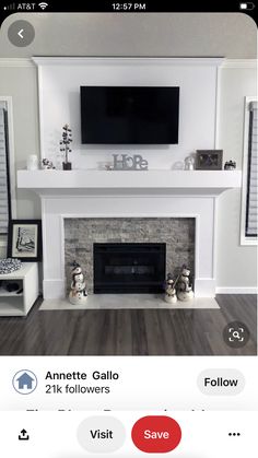 the fireplace is white and has a flat screen tv above it