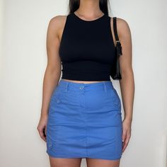 "Reworked skirt made from PreLoved cargo trousers, dusty blue colour with front and back pockets with button closure.  Colour: Light Blue Style: Cargo Skirt Size: Best fits UK 12 (US 8)* Measurements: Waistband - 15\" Length - 15\"   Model: Size Top UK 8/10 (US 4/6) Bottoms UK 10/12 (US 6/8) Height 5ft5\"   *Please contact us if you would like this item to be altered to fit a smaller size." Y2k Blue Skirt With Pockets, Blue Y2k Skort With Pockets, Blue High Waist Cotton Cargo Skirt, Casual Blue Cotton Cargo Skirt, Blue Spring Cargo Skirt With Pockets, Casual Blue Denim Skirt With Side Pockets, Y2k Style Fitted Cargo Skirt With Pockets, Blue Utility Cargo Skirt For Spring, Spring Blue Utility Cargo Skirt