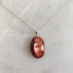 This stunning Pendant is set in 14k Solid Yellow Gold with Natural Sunstone (Feldspar Crystal) with utmost precision. It is a unique gemstone Pendant for nearly every occasion and is completely hassle-free jewelry. ITEM DETAILS: *  GEM: Sunstone * GEM SIZE: 18x27mm * GEM SHAPE: Oval * Gem WEIGHT: 36.83 carats * Gold Purity: 14KT * Gold Weight: 0.75 gram * Total Weight: 8.13 gram The Gold purity is guaranteed and it comes with authentic 14KT gold hallmark. Since my items are handmade, they are absolutely nickel and lead free. CUSTOMIZATION: * Gemstone customization is available and it can be substituted with a gem of your choice. Kindly message me for the same. PACKAGING * The Pendant comes with layers of safe and secure wrapping along with Free handmade jewelry box with every purchase. ➡️H 14k Gold Oval Amber Jewelry, Oval Yellow Gold Jewelry With High Luster, Oval Yellow Gold High Luster Jewelry, Gold Gemstones With Bezel Setting In Fine Jewelry, Elegant Oval Amber Gemstones, Polished 14k Gold Amber Jewelry, 14k Gold Amber Jewelry With Polished Finish, Oval Fine Jewelry With High Luster, Oval 14k Gold Jewelry With High Luster