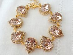 "Pink blush teardrop swarovski crystal bracelet, Bridal bracelet, Bridesmaids gift, Vintage pink, Swarovski crystals bracelet, Gold or silver THIS IS \"TINA ELDOR JEWELRY\" ORIGINAL DESIGNE!! Exquisite and so unique. This is a stunning bracelet that can be custom made with other color combinations, as per your request. Please contact me. It would be a great wedding accessory for a bride, mother of bride, mother of groom and bridesmaids. It is made of 14k gold plated brass and Genuine Austrian Sw Pink Crystal Wedding Bracelets, Groom And Bridesmaids, Morganite Bracelet, Tennis Bracelet Gold, Bridal Cuff, Pink Swarovski, Swarovski Crystal Bracelet, Swarovski Bracelet, Bracelet Wedding